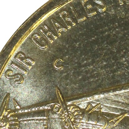 'C' mint-mark on a 1997-C (Kingsford) One Dollar piece.