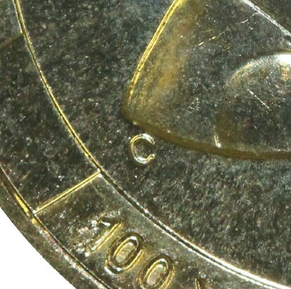 (C) privy-mark on 2010-C (Coin Centenary) one dollar piece.