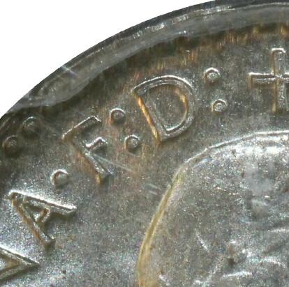 Defender of the Faith 'F.D' inscription on a 1955 Sixpence.